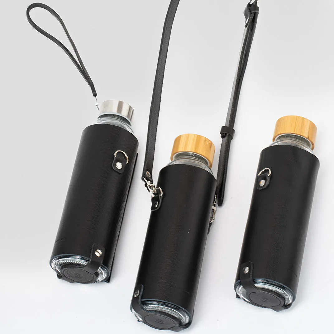 Leather water bottle holder with strap and glass bottle